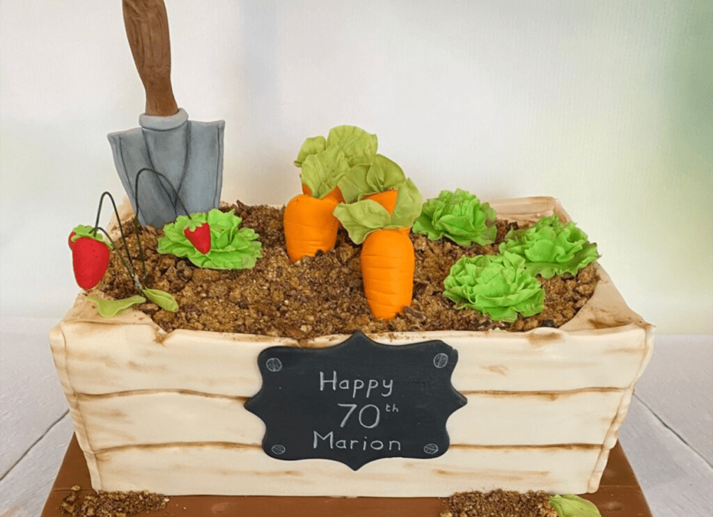 Bespoke gardener’s birthday cake with sugar vegetables, window box cake, 70th birthday cake. Made in St Albans.