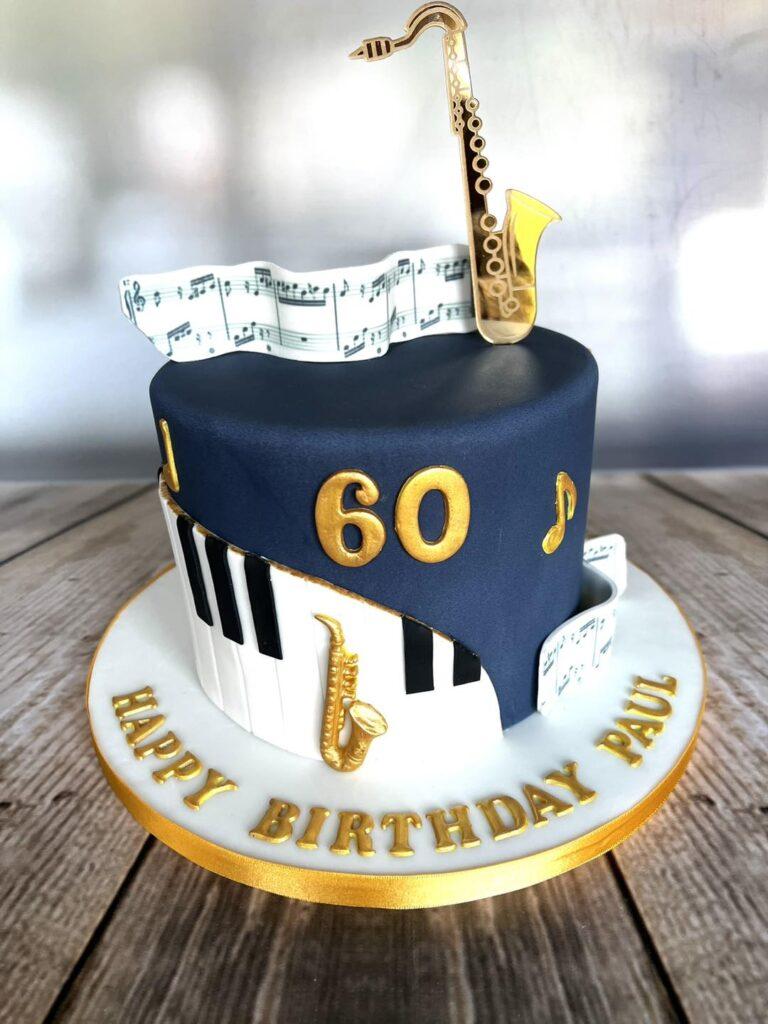 60th birthday cake. Saxophone cake finished in navy blue fondant and finished with piano keys in black and white