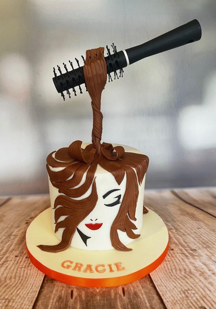 Cake for a hairdresser with a suspended hairbrush. Made by Julies Cake Company | St Albans
