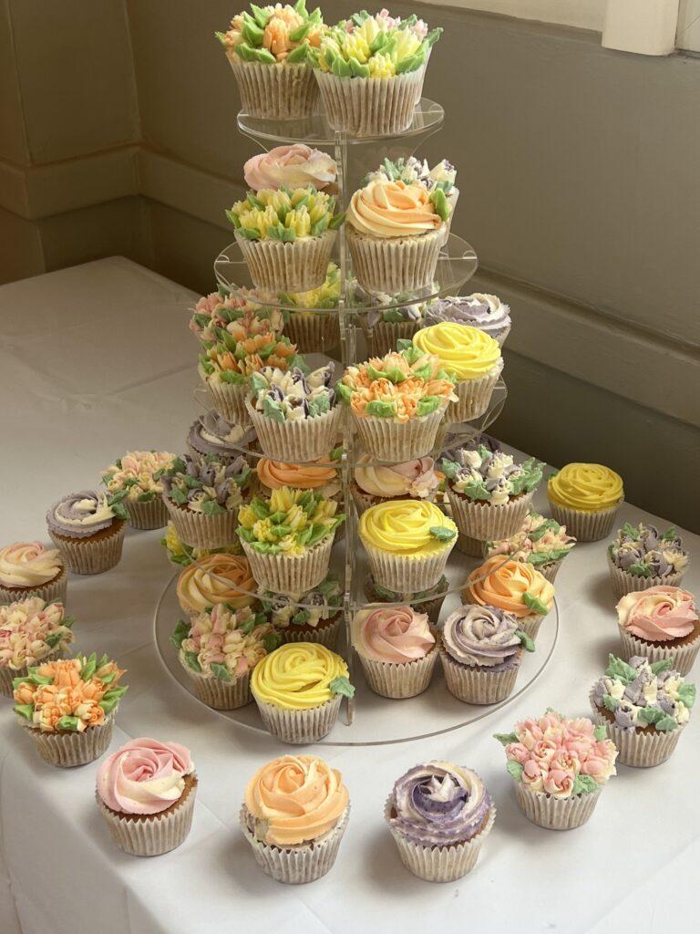 Floral piped cupcakes in bright summer colours.